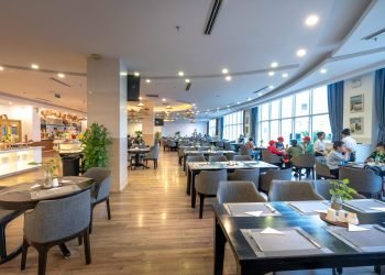 Spacious restaurant interior with guests dining and modern decor.