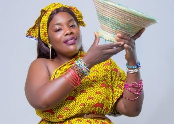 Colorful portrait of an African woman in traditional attire holding a woven basket.